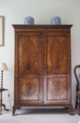 A 19th century mahogany wardrobe with double panelled doors and splayed bracket feet,