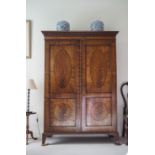 A 19th century mahogany wardrobe with double panelled doors and splayed bracket feet,