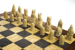 A cased resin replica of the British Museum Lewis chess set with another chess board