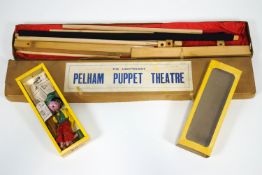 A boxed Pelham puppet lightweight theatre with a curtained proscenium,