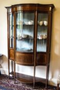 An Edwardian mahogany display cabinet with bow fronted glass,