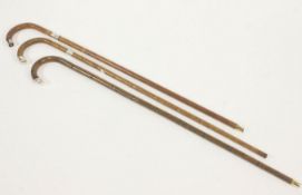 Three walking sticks, two with silver tips, Birmingham 1926,