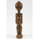 An African hardwood Fetish figure, depicting a standing female in a bead collar holding a pot,