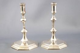 A pair of cast Sterling silver George I style taper sticks, of octagonal baluster form,