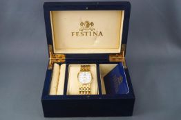 An 18ct yellow gold (stamped) Festina wristwatch. Quartz movement, 18ct gold linked bracelet.