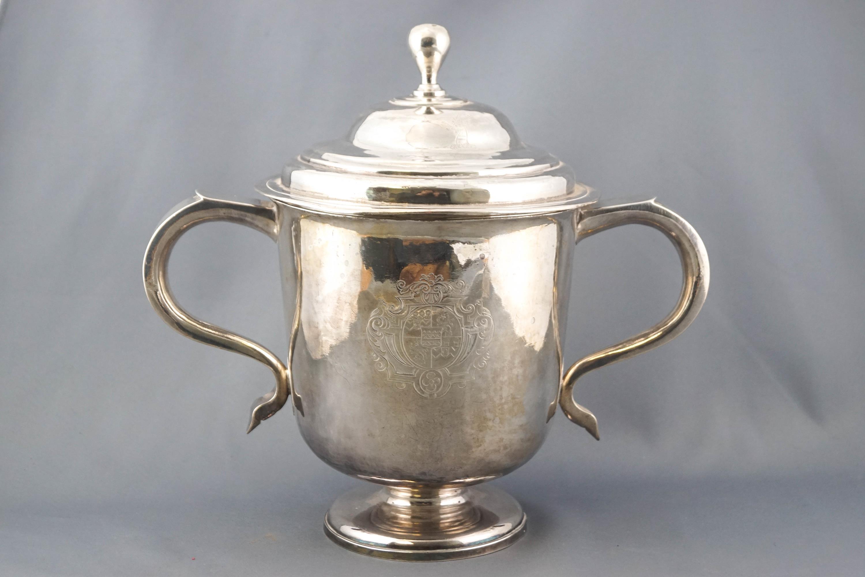 A Queen Anne Britannia Standard two handled cup and cover, of very plan bell form on a domed foot,