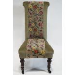 A 19th century Prie Dieu with central panel of floral embroidery raised on turned mahogany legs,
