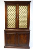 A 19th century mahogany bookcase, the base with twin panelled doors,