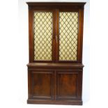 A 19th century mahogany bookcase, the base with twin panelled doors,
