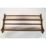 A set of Ercol hanging shelves, of two tier form with shaped sides, makers label ,