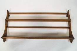 A set of Ercol hanging shelves, of two tier form with shaped sides, makers label ,