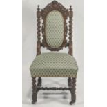 A 19th century oak chair, with foliate carved arched top rail,upholstered back panel and seat,