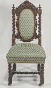 A 19th century oak chair, with foliate carved arched top rail,upholstered back panel and seat,