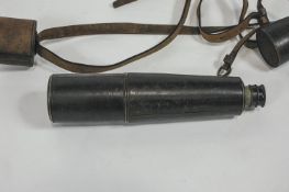 A Cooke & Sons leather and brass three draw telescope, with carry strap and end caps,