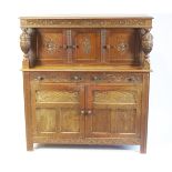 A 17th century style carved oak court cupboard,