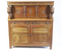A 17th century style carved oak court cupboard,