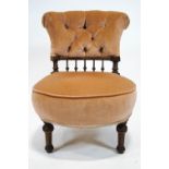 A Victorian nursing chair with button back on turned tapering fluted legs,