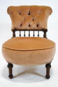 A Victorian nursing chair with button back on turned tapering fluted legs,