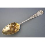 A bottom marked Old English pattern berry spoon with repousse decorated gilt bowl and an engraved