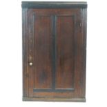 A George III oak corner cabinet,
