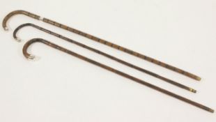 Three walking sticks with rubbed silver tops, 91.