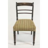 Four late Regency mahogany dining chairs with plain rail backs on stuff over seats raised on