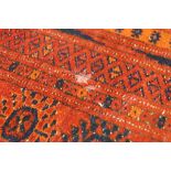 An Afghan carpet with red ground,
