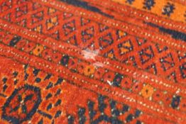 An Afghan carpet with red ground,