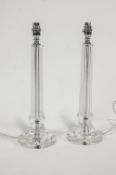 A pair of cut glass table lamps, of column form, on flared bases,