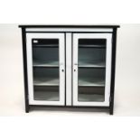 A 1950's white enamel cabinet with black enamel banding,