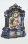 An Edwardian blue and gilt earthenware mantel clock, decorated with figures,