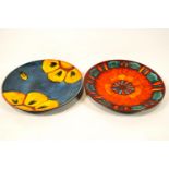 Two brightly decorated Poole pottery chargers,