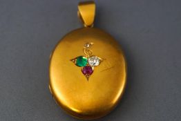 A large yellow metal oval picture locket set with an old European cut diamond estimated to weigh 0.