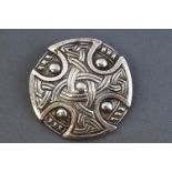 A white metal celtic design circular brooch. Pin and 'C' catch.