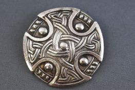 A white metal celtic design circular brooch. Pin and 'C' catch.