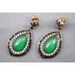 A yellow and white metal large pair of drop earrings each set with a pear shape cabochon jade