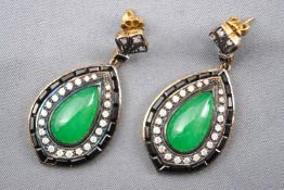 A yellow and white metal large pair of drop earrings each set with a pear shape cabochon jade