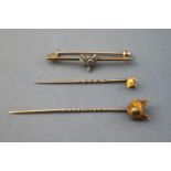 A collection of three fox head pins/brooches to include: One bar brooch having a central fox head