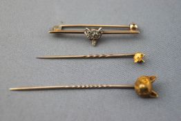 A collection of three fox head pins/brooches to include: One bar brooch having a central fox head