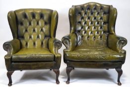A leather wing armchair with button back and stud detail, with another similar.