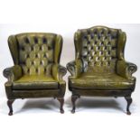 A leather wing armchair with button back and stud detail, with another similar.