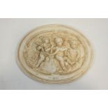 A moulded composite wall plaque, decorated with putti,