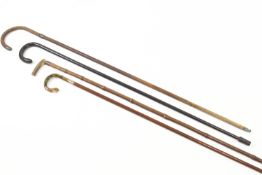 Four ladies walking canes, in hardwood and bamboo, one with a silver mounted horn handle,