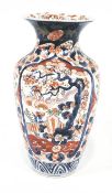 An early 20th century Imari vase, decorated with panels of birds and foliage,