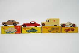 A group of four boxed Dinky toys, to include the 157 Jaguar XK120 coupe, 108 MG Midget Sports,