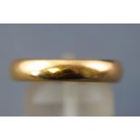 A yellow metal court shape wedding ring, size: S. Hallmarked 22ct gold. 6.