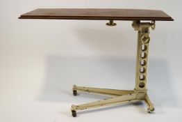 A cast iron and mahogany adjustable reading or bed table,