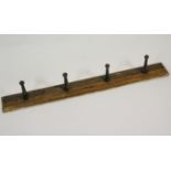 A late 19th century wall mounted oak whip rack,