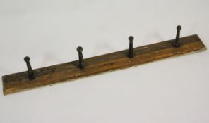 A late 19th century wall mounted oak whip rack,