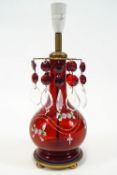 A ruby glass and brass lustre lamp, of baluster form,